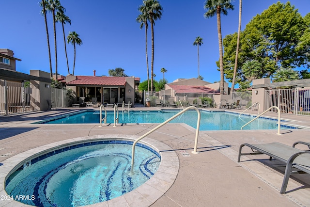 view of pool with a community hot tub and a patio area