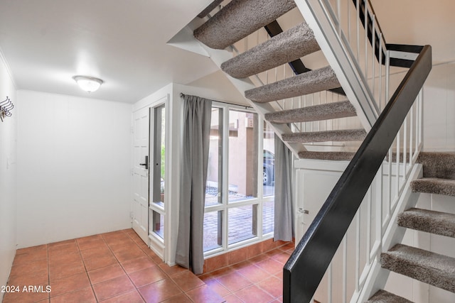 stairs with tile patterned floors