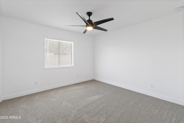 spare room with carpet and ceiling fan