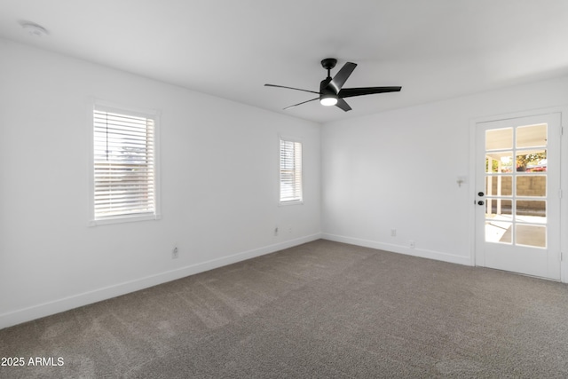 spare room featuring carpet floors and ceiling fan