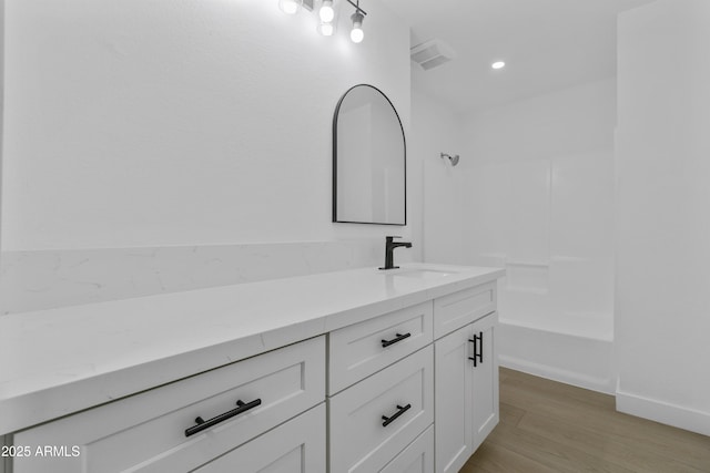 bathroom with hardwood / wood-style flooring and vanity