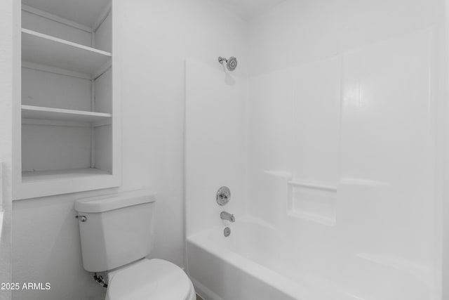 bathroom featuring toilet and  shower combination