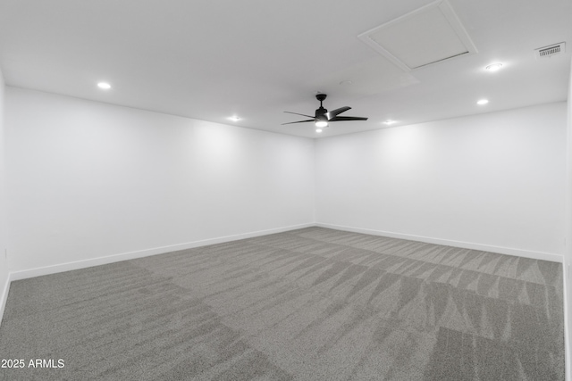 carpeted spare room featuring ceiling fan