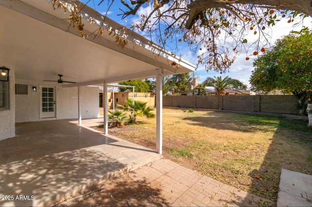 view of yard with a patio and ceiling fan