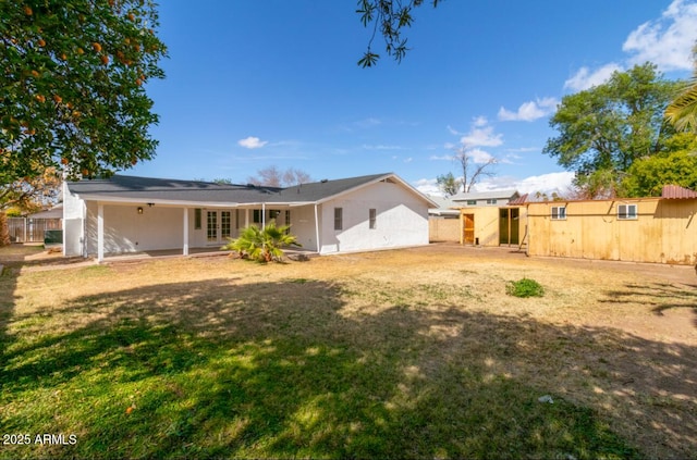 back of property featuring a lawn