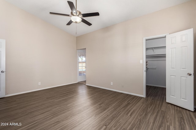 unfurnished bedroom with ceiling fan, a closet, dark hardwood / wood-style floors, and a spacious closet