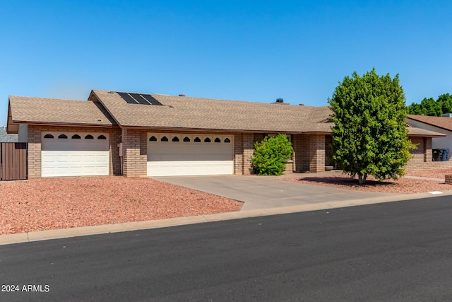 6034 E Hillview St, Mesa, AZ 85205 - ranch-style house featuring an attached garage, brick siding, roof with shingles, and driveway