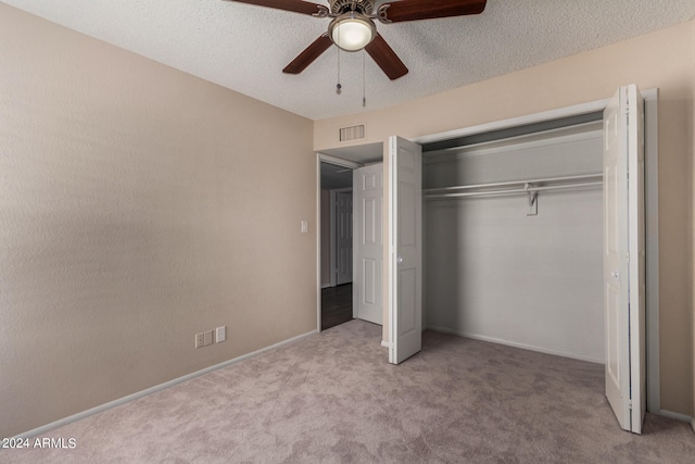 unfurnished bedroom featuring a closet, ceiling fan, and light colored carpet