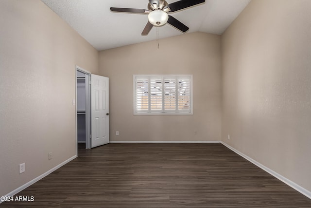 unfurnished bedroom with vaulted ceiling, dark hardwood / wood-style flooring, and ceiling fan