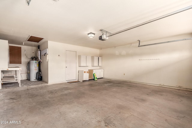 garage with a garage door opener and electric water heater