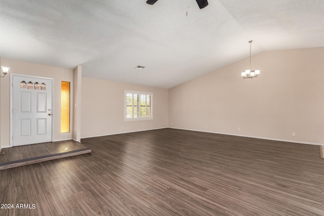 entrance foyer with a textured ceiling, ceiling fan with notable chandelier, lofted ceiling, and dark wood-type flooring