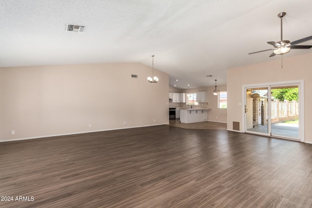 unfurnished living room with vaulted ceiling, sink, ceiling fan with notable chandelier, and dark wood-type flooring