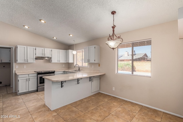 kitchen featuring pendant lighting, sink, kitchen peninsula, white cabinetry, and stainless steel stove