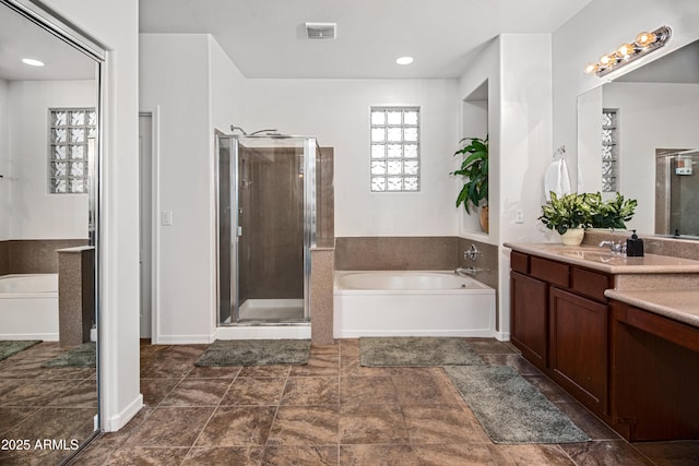4221 S Fireside Ct, Gilbert, AZ 85297 - bathroom with vanity, a garden tub, and a shower stall