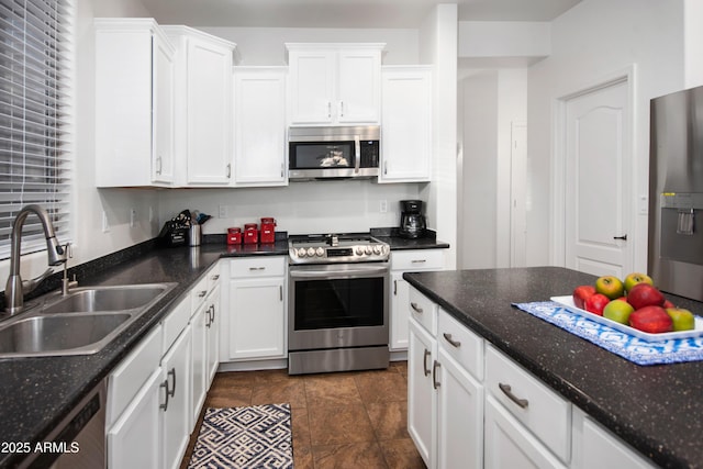 4221 S Fireside Ct, Gilbert, AZ 85297 - kitchen with stainless steel appliances, a sink, white cabinets, and dark stone countertops