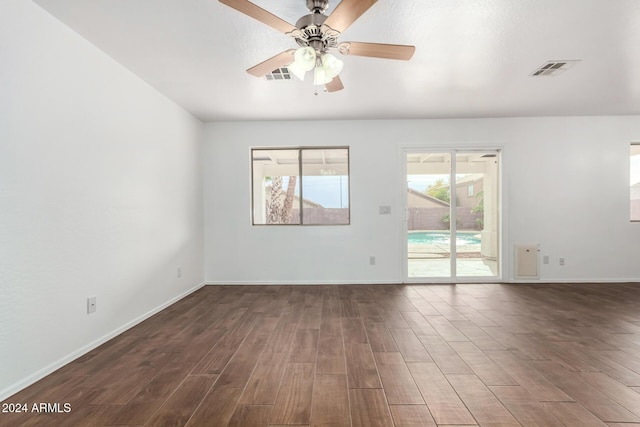 spare room with dark hardwood / wood-style floors and ceiling fan