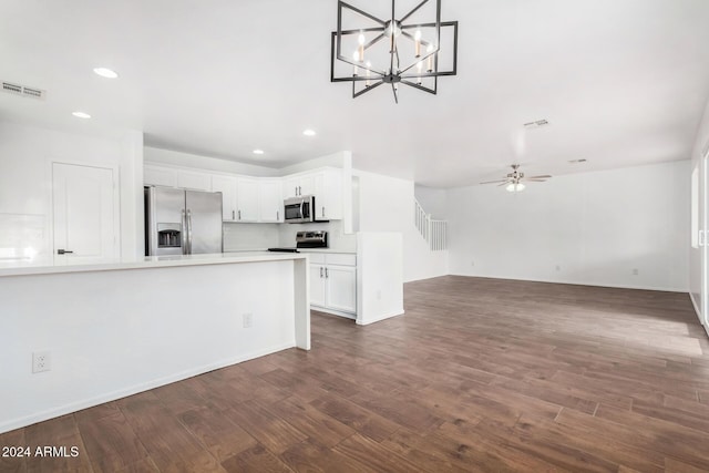 kitchen featuring white cabinetry, hanging light fixtures, stainless steel appliances, dark hardwood / wood-style floors, and ceiling fan with notable chandelier