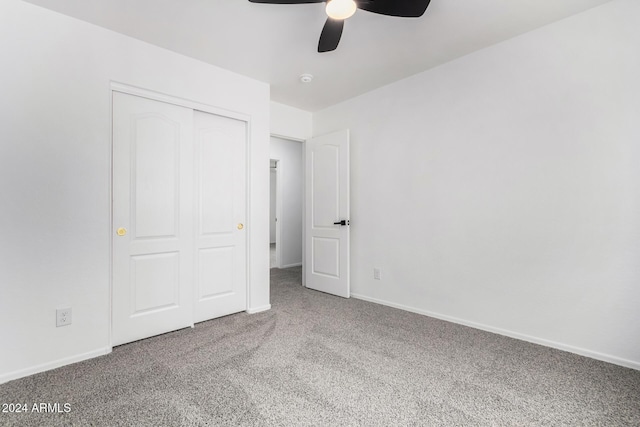 unfurnished bedroom featuring carpet flooring, ceiling fan, and a closet