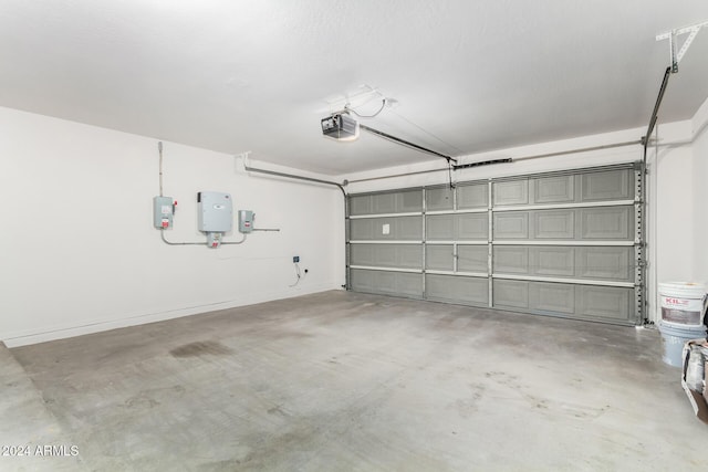 garage featuring electric panel and a garage door opener