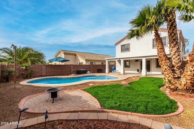 view of pool with a patio area, a yard, and an outdoor fire pit