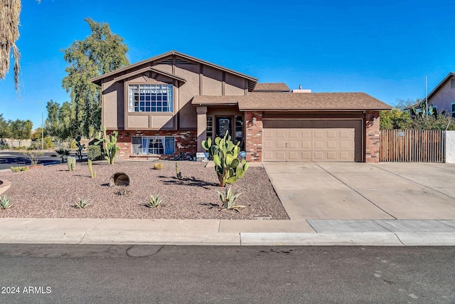 13051 N 75th Dr, Peoria, AZ 85381 - split level home featuring brick siding, a garage, driveway, stucco siding, and fence
