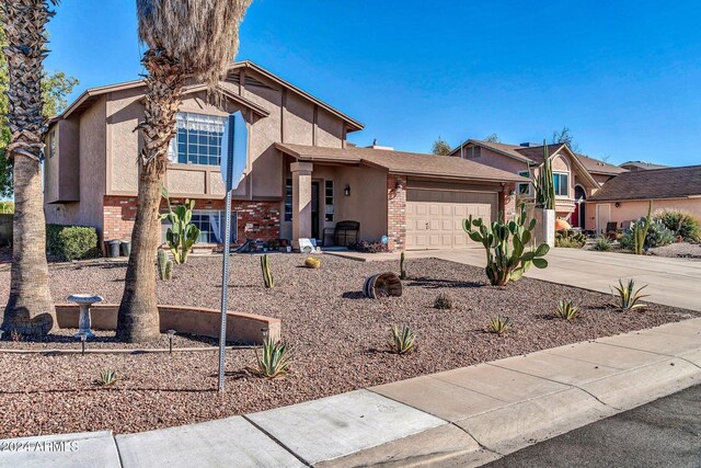 13051 N 75th Dr, Peoria, AZ 85381 - view of front of property with concrete driveway, a garage, stucco siding, and brick siding