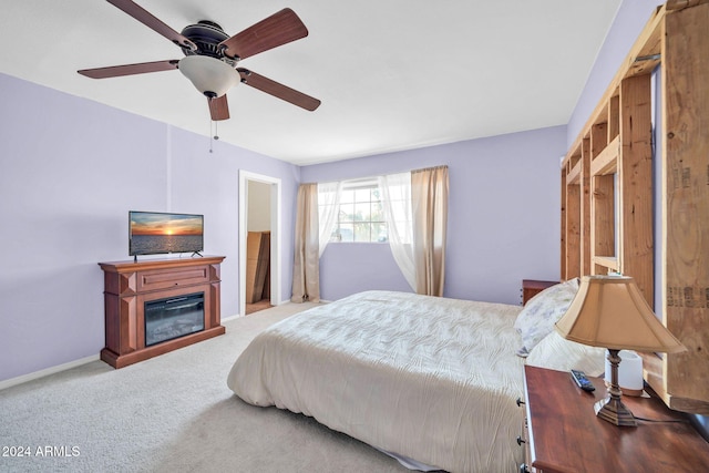 13051 N 75th Dr, Peoria, AZ 85381 - carpeted bedroom featuring a glass covered fireplace, baseboards, and ceiling fan