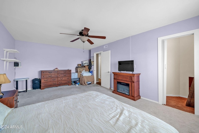 13051 N 75th Dr, Peoria, AZ 85381 - bedroom featuring carpet flooring, a glass covered fireplace, ceiling fan, and baseboards