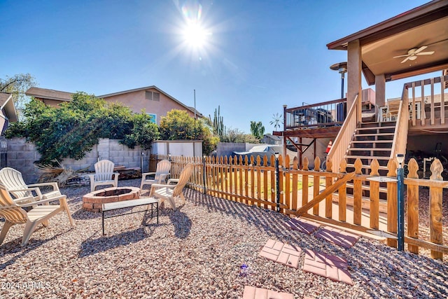 13051 N 75th Dr, Peoria, AZ 85381 - fenced backyard with an outdoor fire pit, stairs, a deck, a ceiling fan, and a patio