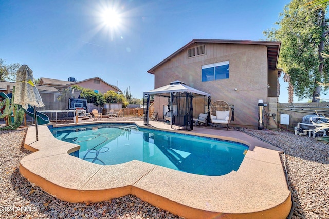13051 N 75th Dr, Peoria, AZ 85381 - view of pool featuring a gazebo, a trampoline, a fenced backyard, and a patio