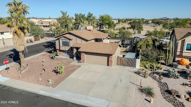 13051 N 75th Dr, Peoria, AZ 85381 - view of front facade with brick siding, a gate, concrete driveway, fence, and a residential view