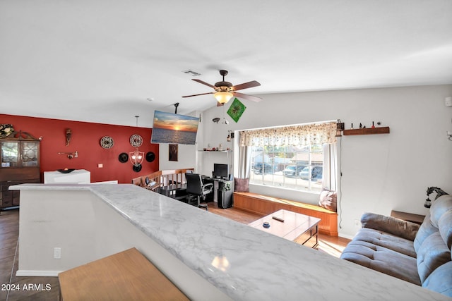13051 N 75th Dr, Peoria, AZ 85381 - living area featuring ceiling fan, a desk, wood finished floors, lofted ceiling, and baseboards
