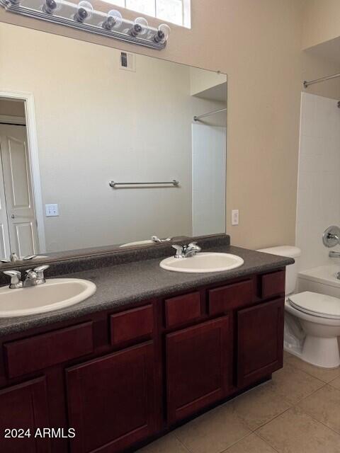 full bathroom with shower / bathing tub combination, toilet, vanity, and tile patterned floors