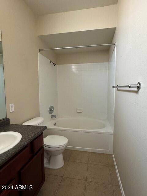 full bathroom with toilet, vanity, tile patterned floors, and tub / shower combination