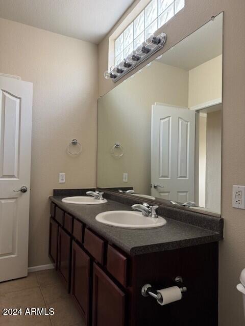 bathroom featuring tile patterned flooring, vanity, and toilet