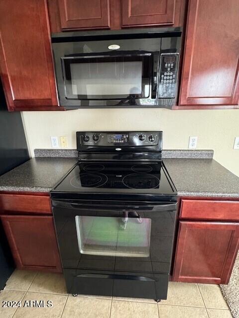 kitchen featuring black appliances and light tile patterned floors