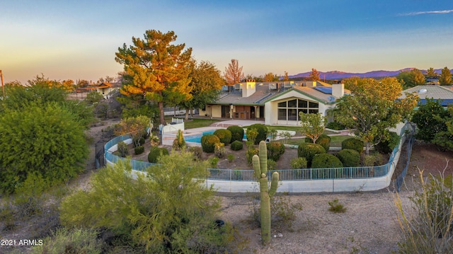 2190 N Vulture Mine Rd, Wickenburg, AZ 85390 - back house at dusk with a patio area