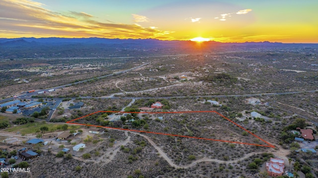 aerial view at dusk featuring a mountain view