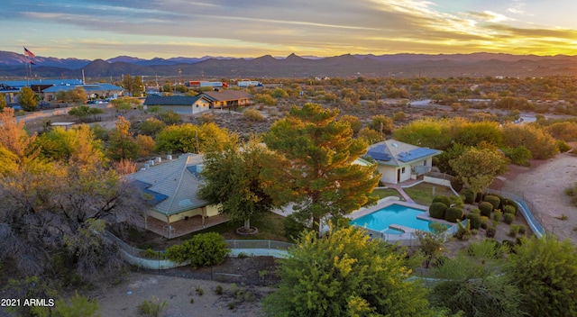 aerial view at dusk featuring a mountain view