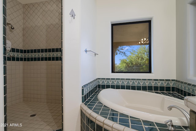 bathroom featuring shower with separate bathtub