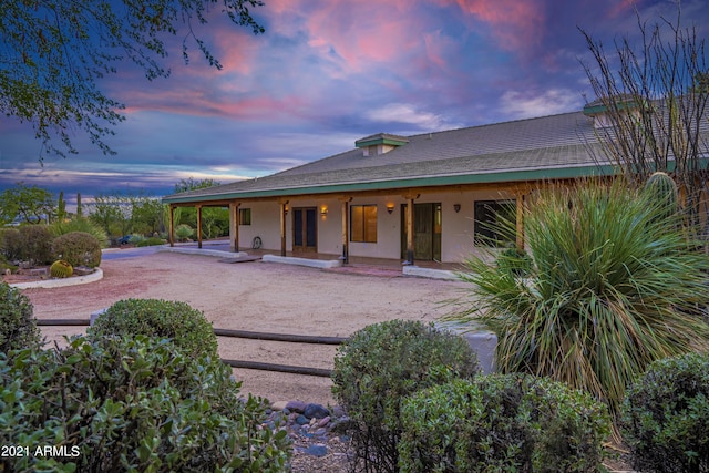 view of back house at dusk