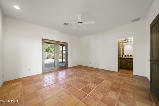 empty room with light tile patterned flooring, ceiling fan, and french doors