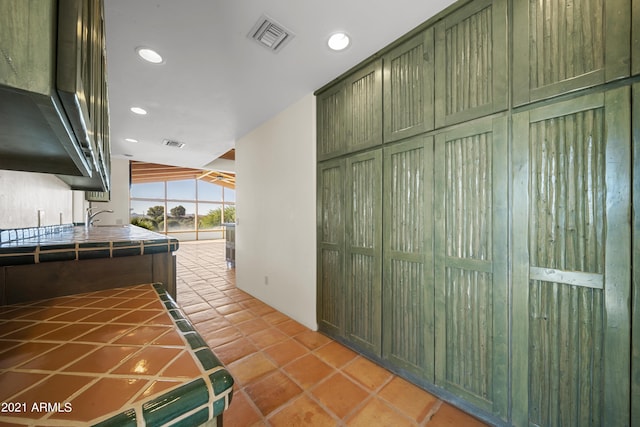 interior space with light tile patterned flooring and vaulted ceiling