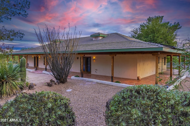 view of back house at dusk