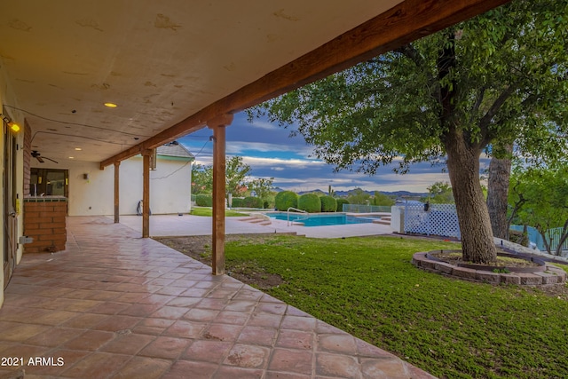 patio terrace at dusk with a lawn