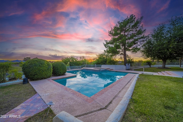 pool at dusk with a yard