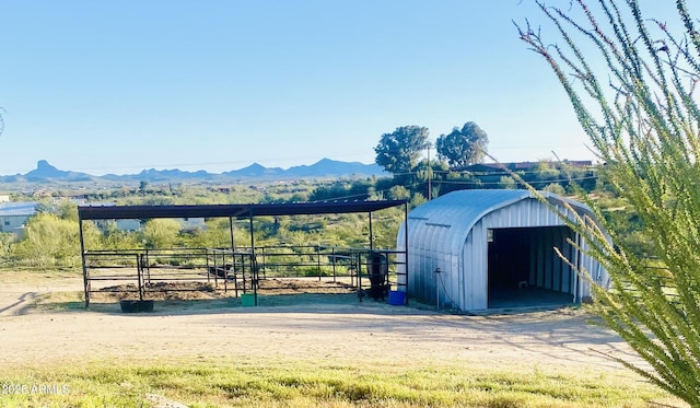 view of outdoor structure featuring a rural view and a mountain view