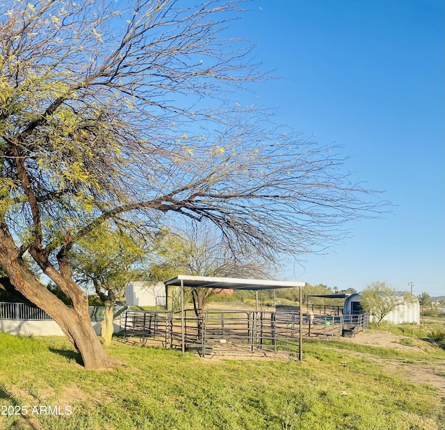 view of yard featuring a rural view and an outbuilding