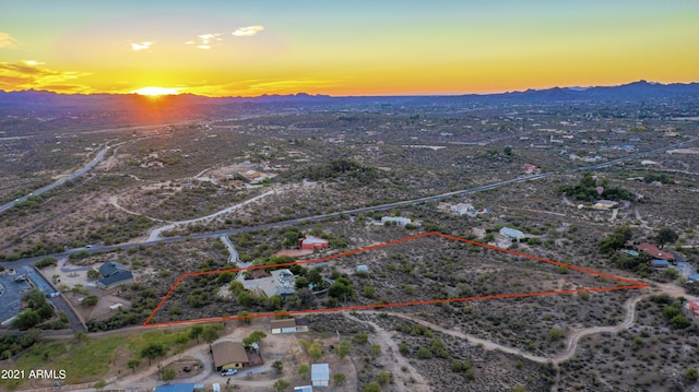 aerial view at dusk featuring a mountain view