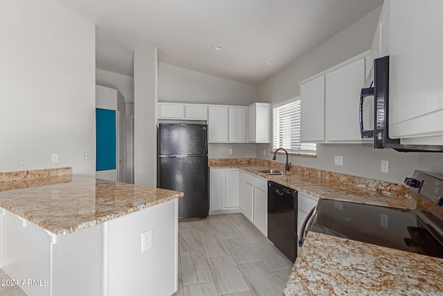 kitchen with white cabinets, vaulted ceiling, kitchen peninsula, and black appliances